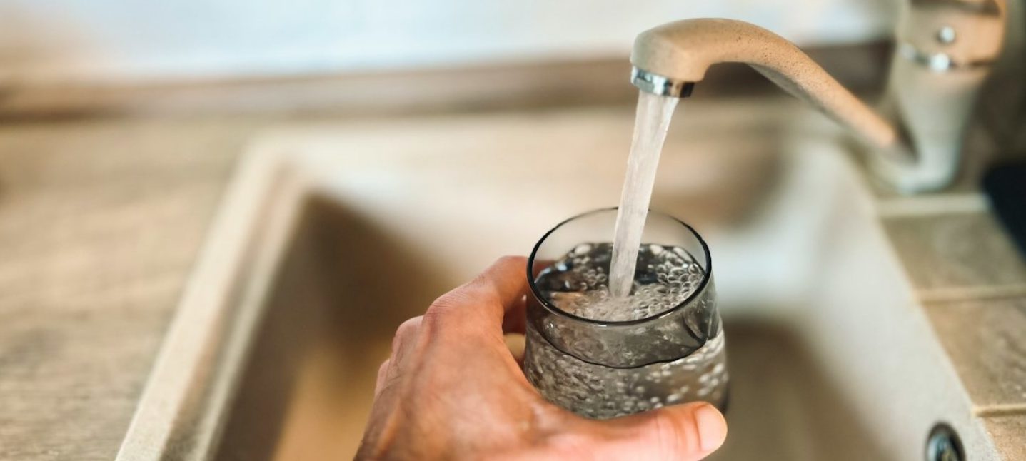 a hand holding a glass of water